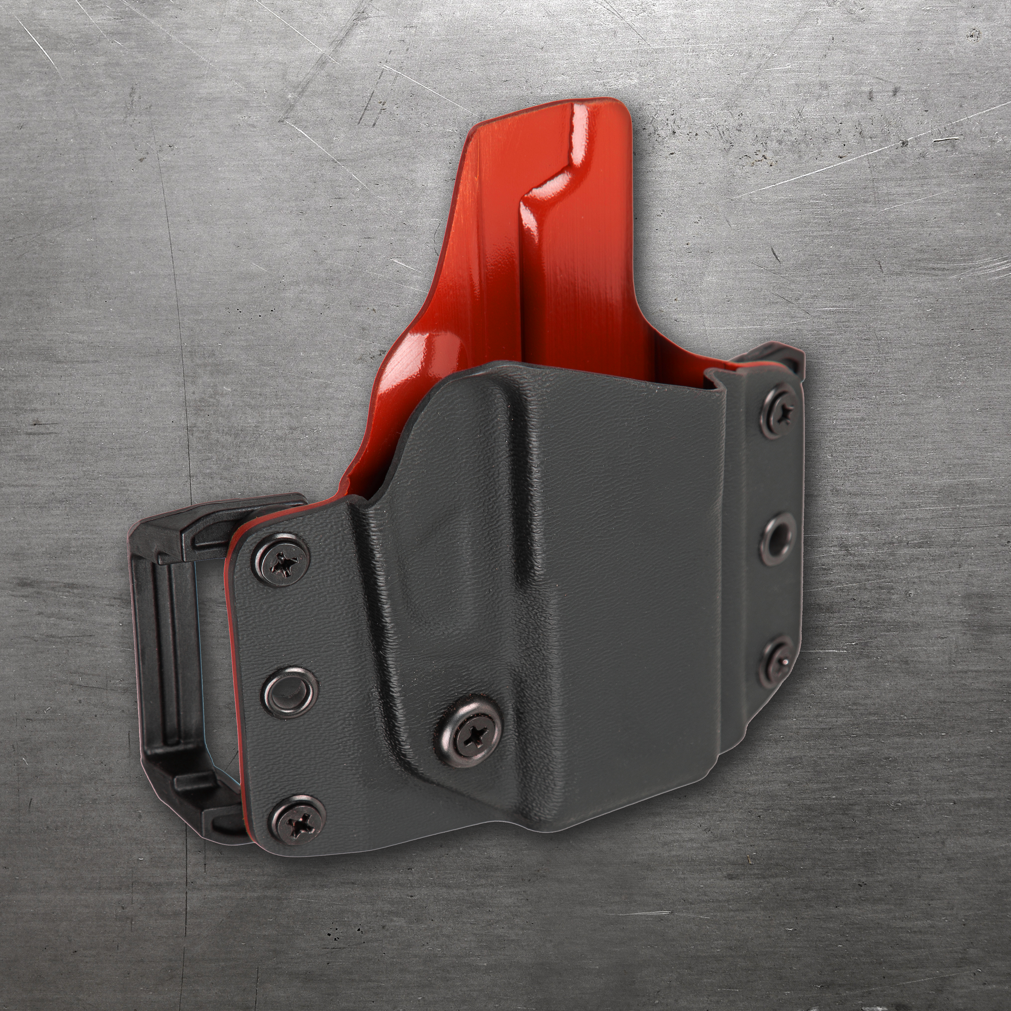 Gray holster with red accent on a metallic background